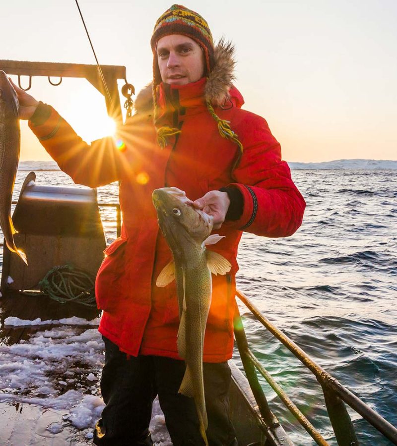 young-fisherman-on-the-boat-with-two-large-fish-VYXLZ5U-resize.jpg